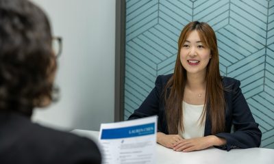 a woman sitting at a table with a piece of paper in front of her
