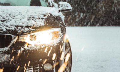 black car on snow covered road during daytime