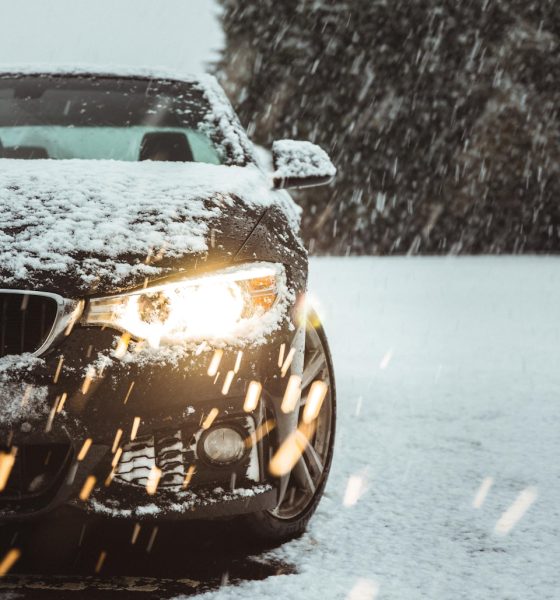 black car on snow covered road during daytime